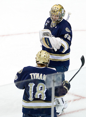 Notre Dame's T.J. Tynan and goaltender Mike Johnson celebrate a goal. The University of Minnesota-Duluth Bulldogs defeated the University of Notre Dame Fighting Irish 4-3 in the opening semi-final of the 2011 Frozen Four at Xcel Energy Center in St. Paul, Minnesota. (Melissa Wade)