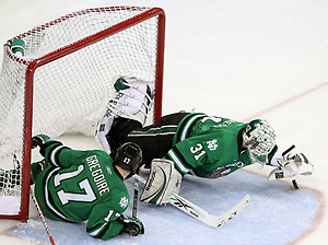 North Dakota goalie Brad Eidsness pounces on a loose puck during the second period. Looking on is Jason Gregoire. No. 8 North Dakota used a three-goal third period to beat No. 4 UNO 6-5 Friday night at Qwest Center Omaha. (Photo by Michelle Bishop) (Michelle Bishop)