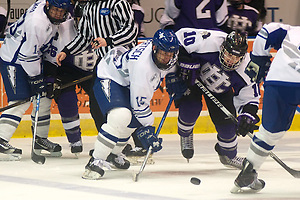 Sean Bertsch (15, white) and Kyle Fletcher (10) fight for a loose puck. (2011 Omar Phillips)