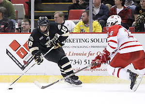 Western Michigan left winger J.J. Crew (10) carries the puck down the ice as Miami's Vincent LoVerde defends his zone during the second period of the CCHA Championship game at Joe Louis Arena in Detroit, MI on March 19, 2011. (Rena Laverty)