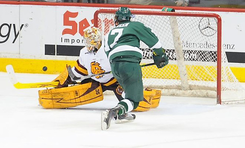 Minnesota-Duluth's Kenny Reiter stops Bemidji State's Jamie MacQueen on a penalty shot. (Tim Brule)