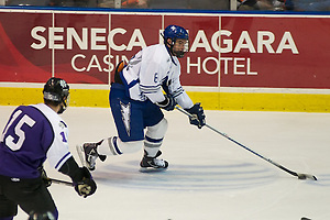 Air Force defenseman Adam McKenzie advances the puck. (2011 Omar Phillips)