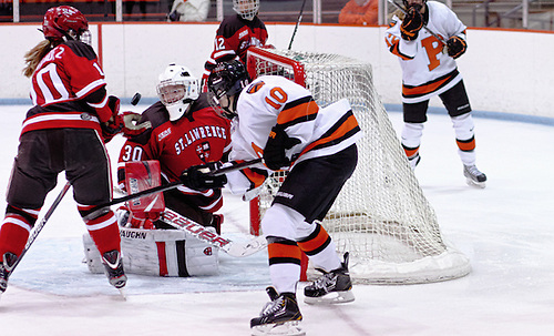 Carmen MacDonald (St. Lawrence - 30) and Brooke Fernandez (St. Lawrence - 10) clear the puck away from Sally Butler (Princeton - 10). (Shelley M. Szwast)