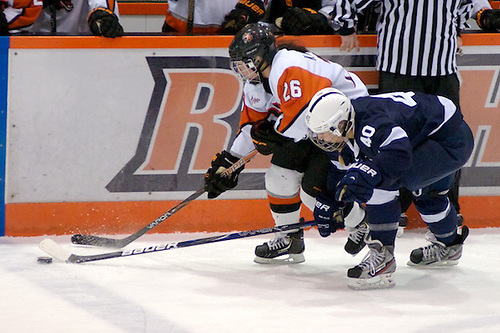 Penn State's Shannon Yoxheimer tries to poke the puck away from Kourtney Kunichika of RIT. (Omar Phillips)