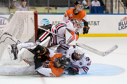 Shawn Cameron (11 - RIT) and Austin Goldstein (12 - Northeastern) collide into Cayden Primeau (31 - Northeastern) (2017 Omar Phillips)