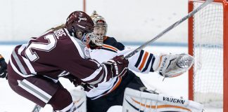 Shae Labbe (Colgate - 12) lifts the puck up and over Kimberly Newell ( Princeton - 33) for a third period goal. ((c) Shelley M. Szwast 2014)