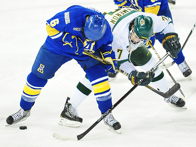 Alaska-Anchorage's Brett Cameron (7) and Alaska-Fairbanks' Michael Quinn (6) battle for control of the puck in the third period. Alaska-Anchorage defeated Alaska-Fairbanks 3-2 in Anchorage in the first of two games for the Governor's Cup. (Sam Wasson)